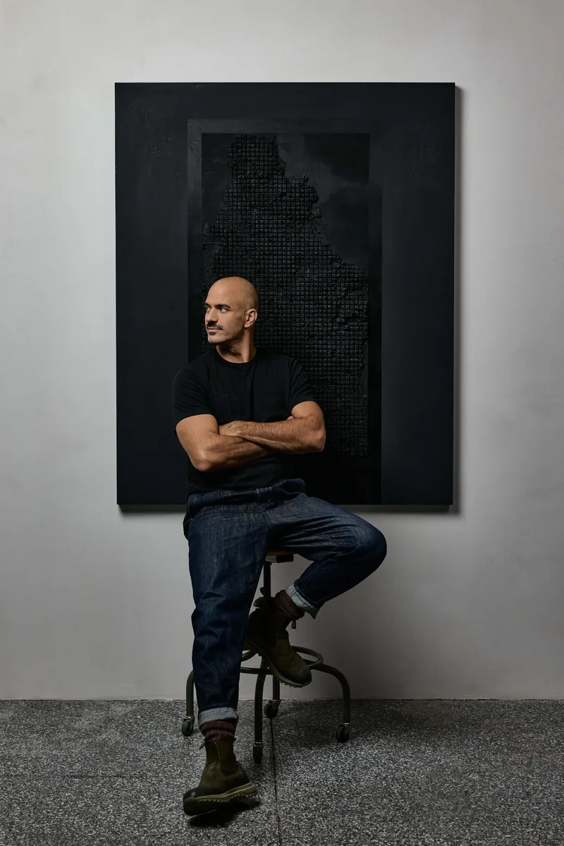 Peter Varga at work in his studio, lit from the side