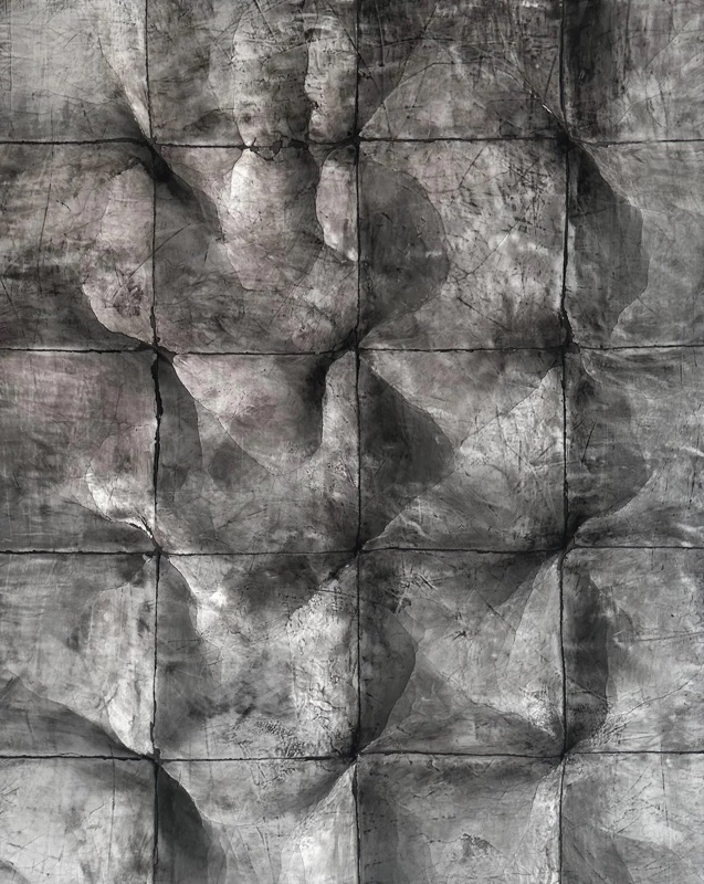 Full-bleed close-up of the folded and faceted grid texture with fine scratches across the surface.
