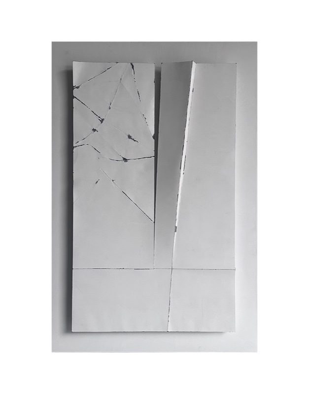 Straight-on gallery shot of the pale relief panel: radiating crack lines beside a smooth diagonal folded panel.