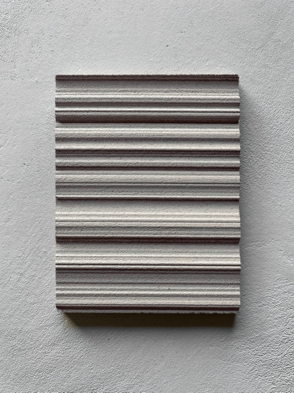 Macro close-up of horizontal fluted ribbing, directly lit to show the fine ridge-and-groove texture.