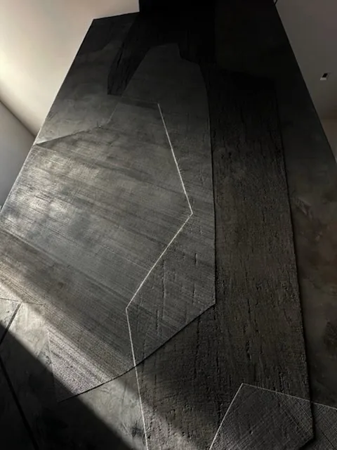 Charcoal layered plaster surface of the elevator-shaft installation, mid-install, Denver