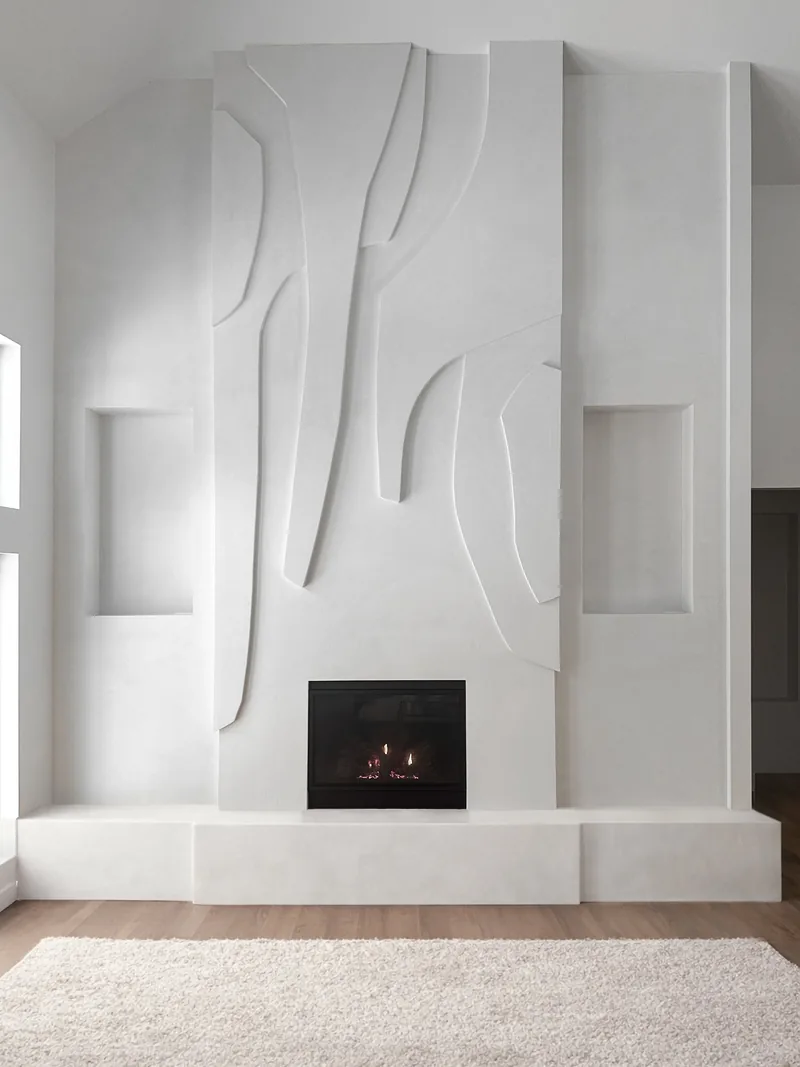Tall view of the sculptural plaster relief rising above the fireplace