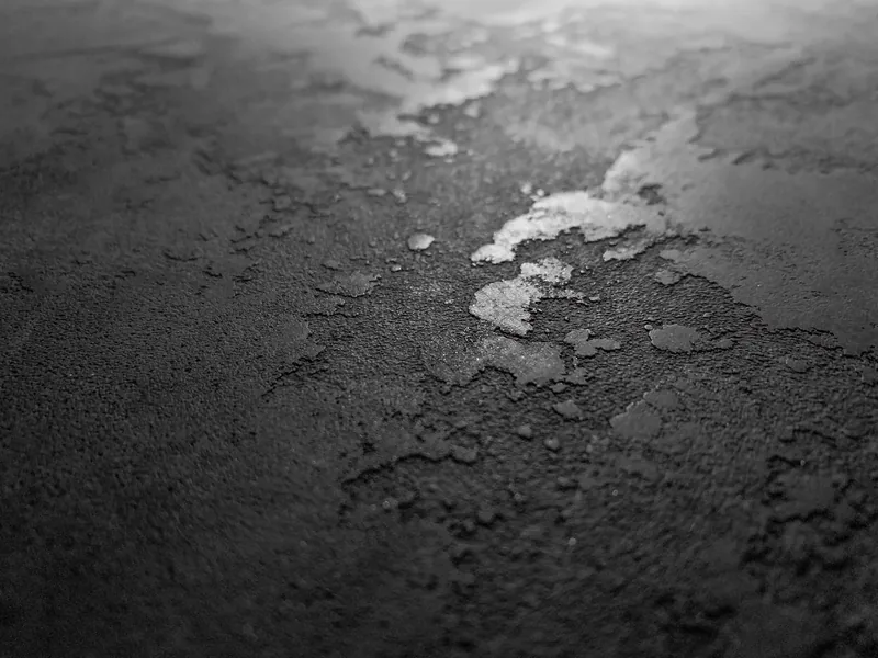 Metal fleck plaster finish specimen, metallic aggregate in a dark mineral field